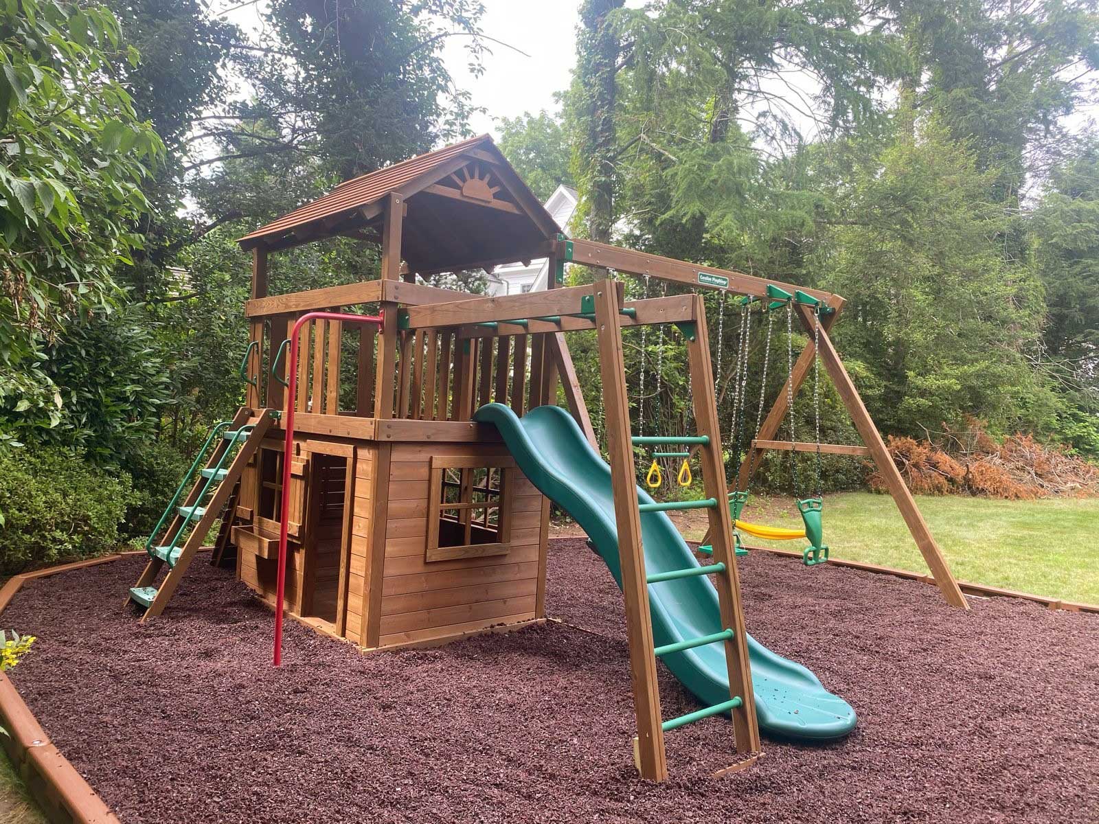 Customer photograph of a Creative Playthings Swing Set in a residential yard.